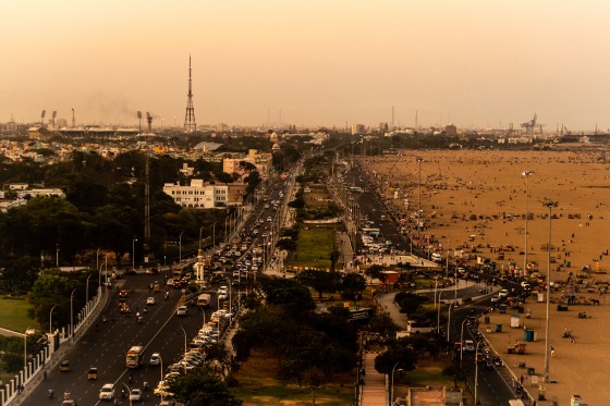 Chennai from the top of Light house at Marina beach. Work and leisure by the road.