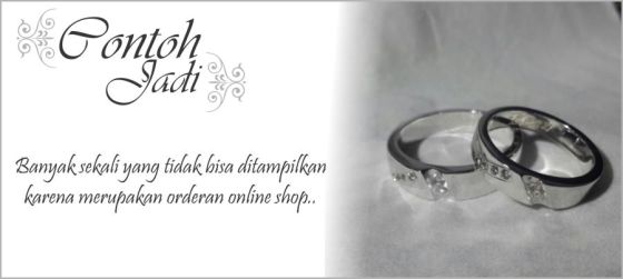 Sepasang cincin kawin dengan bahan palladium (cowok) dan emas putih (cewek) dengan batu berlian.