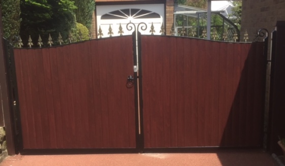 Wrought iron gates with composite deckboard panelling for extra privacy