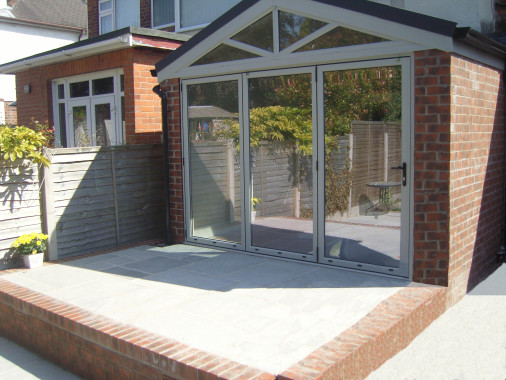 Here we removed an old lean to conservatory roof and replaced with a new gable style solid roof, with bi-fold doors across the front. We built the new patio too, to transform a previously ugly conservatory into a modern extension.