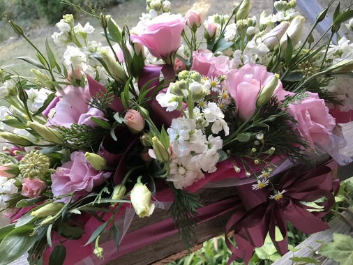 Pastel rustic box arrangement with Lizzy, stock, spray roses and mixed seasonal foliages