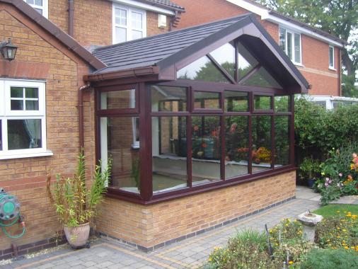 Another conservatory roof replacement, here with a gable style roof with an overhang to create a chalet effect. Also using slate effect tiles to match the house.
