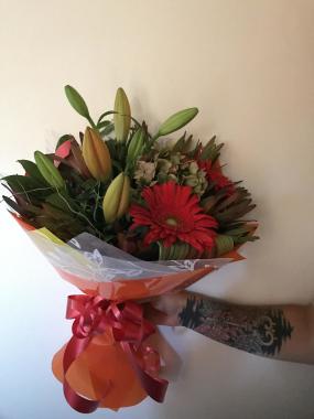 Bright bouquet orange lily to open , gerbs, hydi, lucs and mixed seasonal foliages